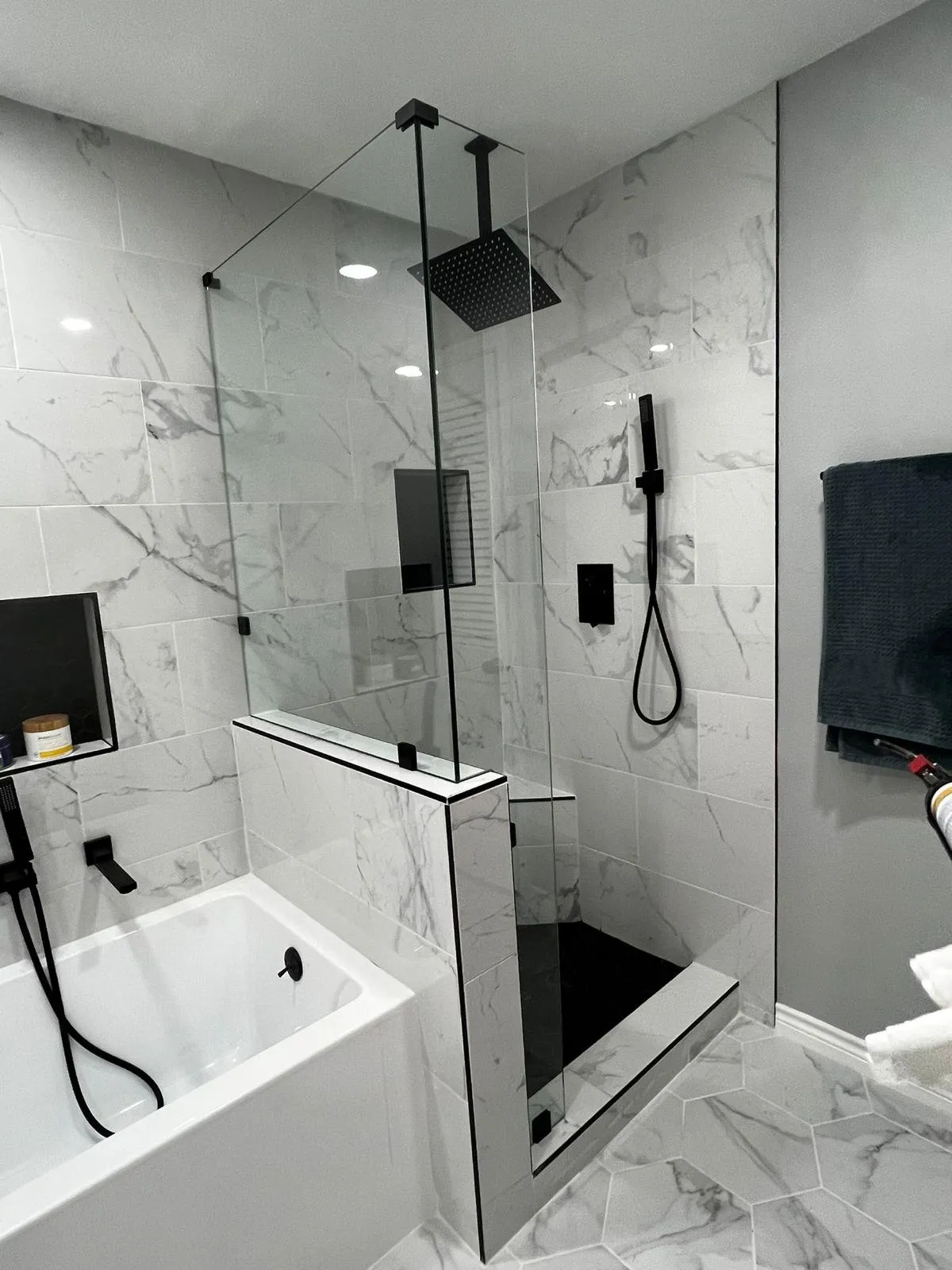 Remodeled bathroom with soaking tub, half wall and walk-in shower with ceiling rain head, Dallas