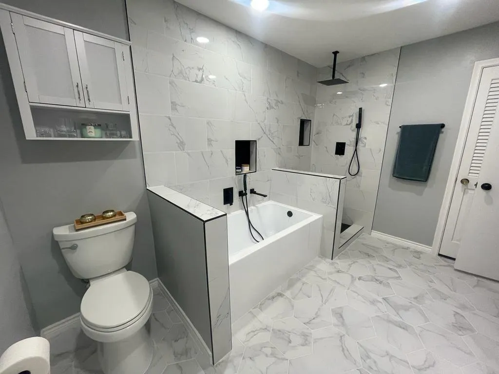 New toilet area and tiled tub wall after the bathroom remodel, Dallas