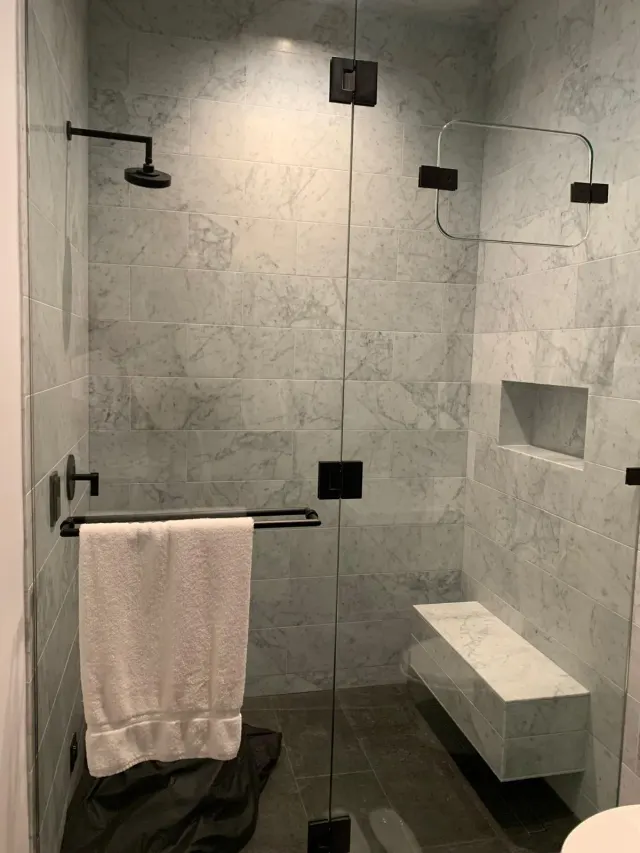 Gray marble-look shower with floating bench