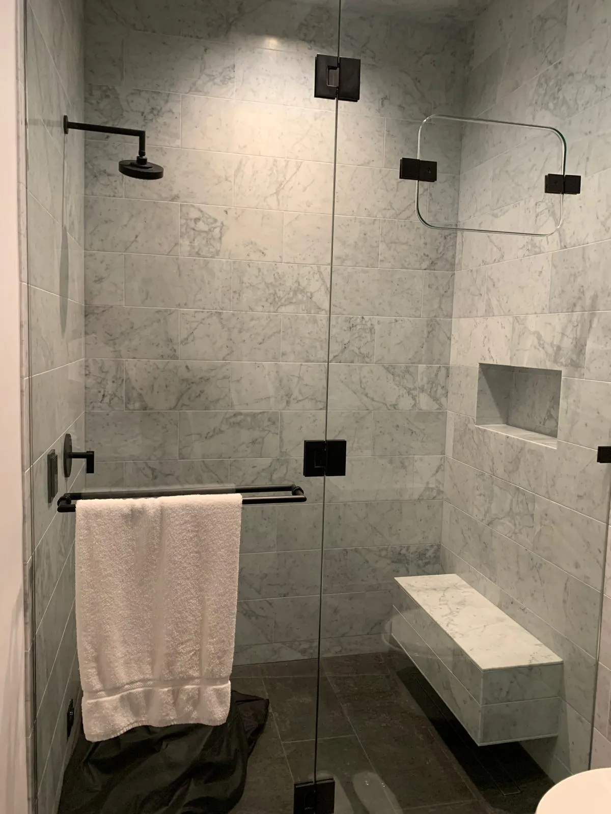 Gray marble-look shower with floating bench, Dallas bathroom remodel