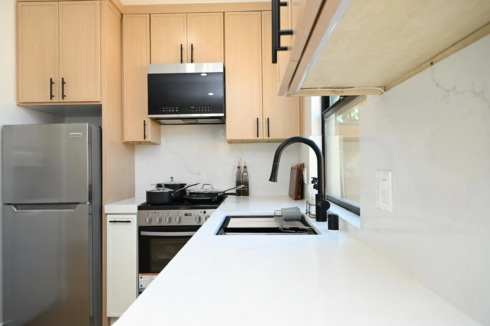 Kitchen sink corner with black faucet and quartz counters